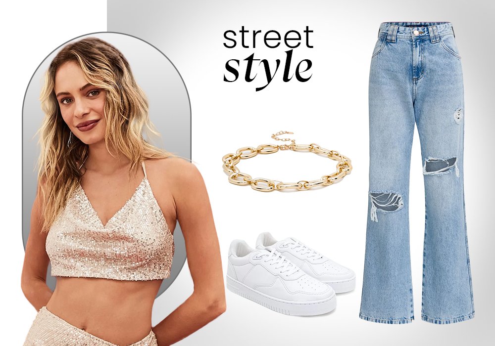 Mulher vestindo um cropped douurado com brilho. Ao lado uma calça jeans, um tenis branco e uma colhar dourado