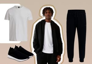 Imagem com fundo bege claro com um homem usando uma blusa de frio preta aberta com uma camiseta branca, e ao lado tem uma calça jogger de moletom preta, uma camiseta de manga curta branca e um sapato preto de sola branca.